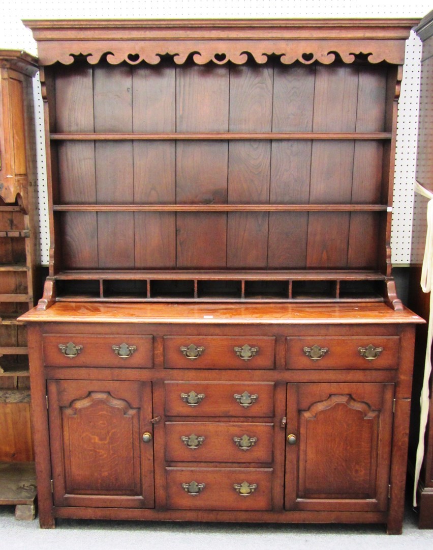 Appraisal: An th century style oak dresser the enclosed two tier