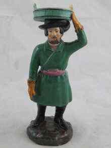 Appraisal: A Russian ceramic figure of a porter carrying a tub