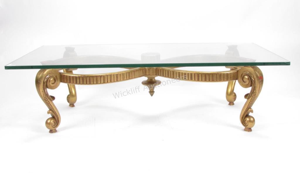 Appraisal: A neoclassical style cocktail table with a thick plate glass