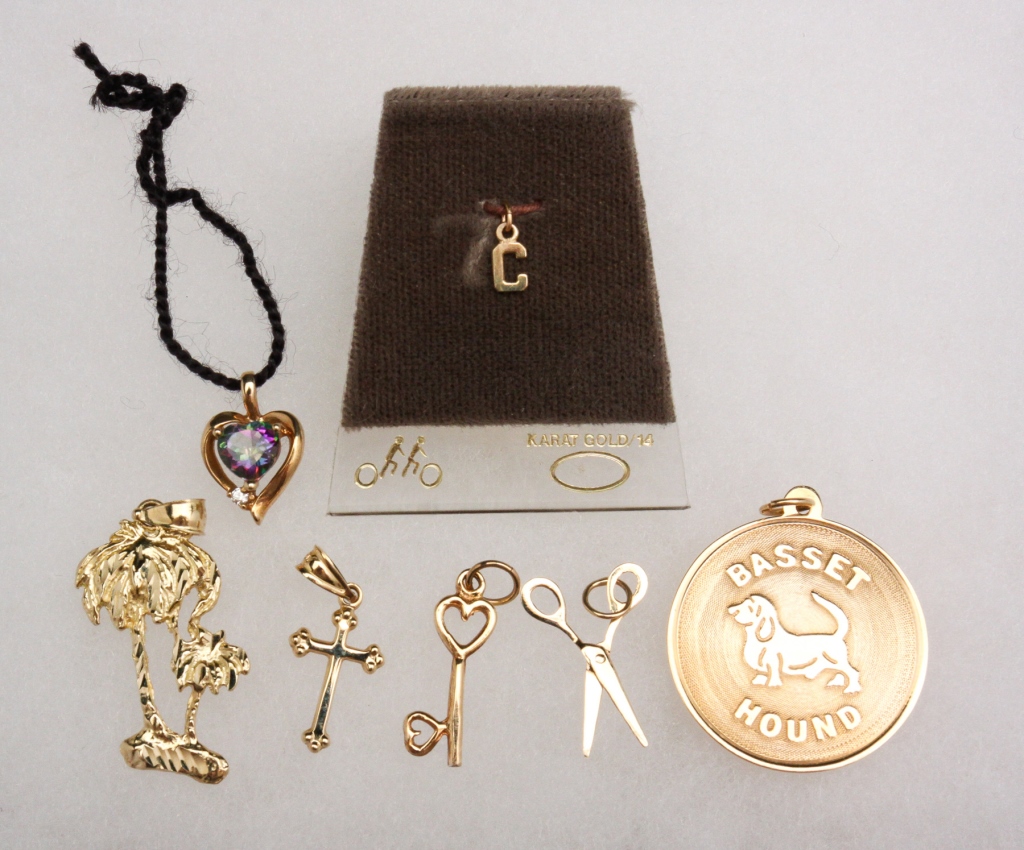 Appraisal: Late th - st century Seven K gold charms consisting