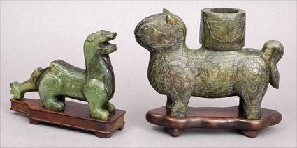 Appraisal: TWO ARCHAISTIC CARVED JADE ANIMALS The larger a feline incised