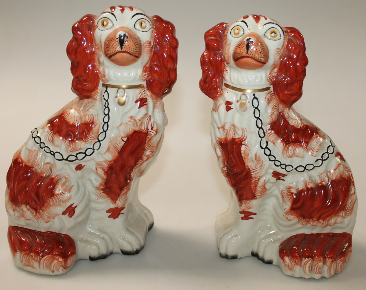 Appraisal: A pair of late thC early thC Staffordshire spaniels each