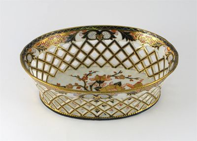 Appraisal: A Derby basket with reticulated sides the centre painted in