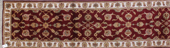 Appraisal: HAND KNOTTED ORIENTAL RUNNER Indo-Persian floral design on madder red