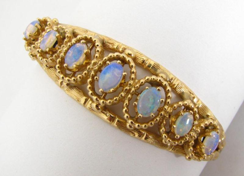 Appraisal: K Yellow Gold Opal Hinged Bangle Bracelet with seven graduated