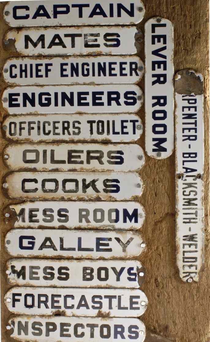 Appraisal: FOURTEEN ENAMELED METAL SHIP'S DOOR SIGNS MOUNTED TO A WOODEN