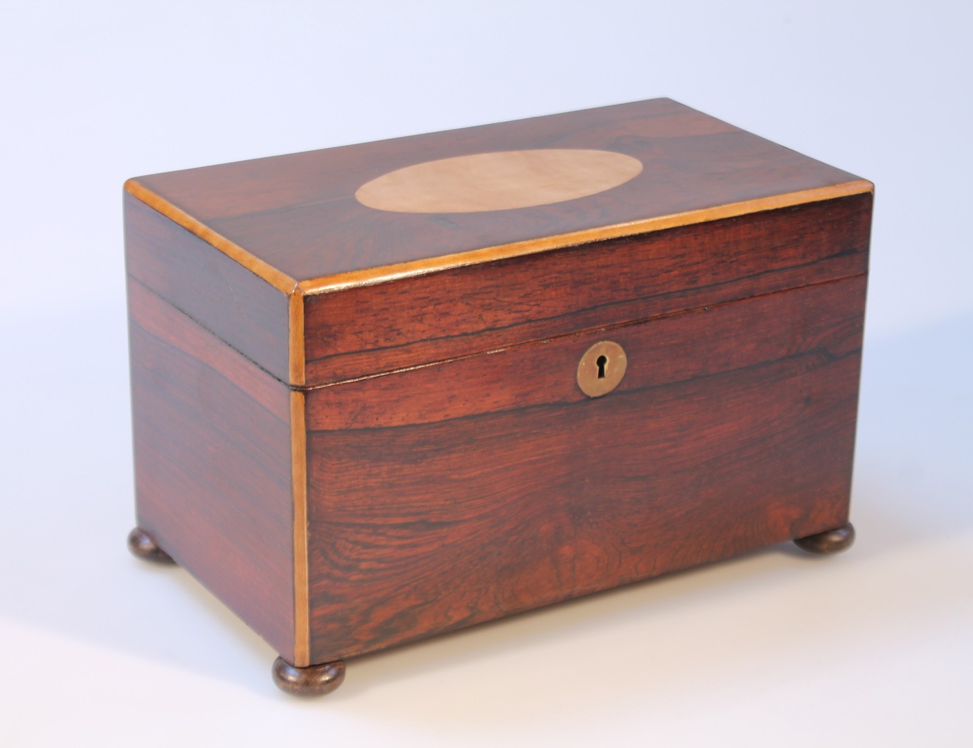 Appraisal: An early thC rosewood satinwood and mahogany tea caddy the