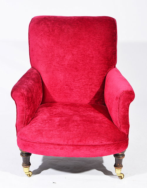 Appraisal: AN ANTIQUE ARMCHAIR with red upholstery scroll arms and turned