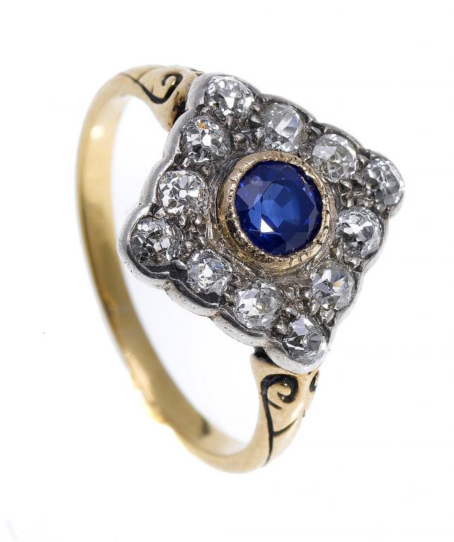 Appraisal: A SAPPHIRE AND DIAMOND LOZENGE CLUSTER RING with central sapphire