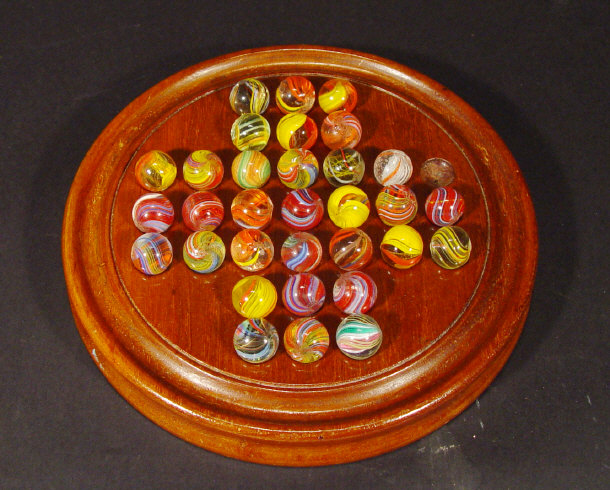 Appraisal: Mahogany solitaire board and a quantity of glass marbles with