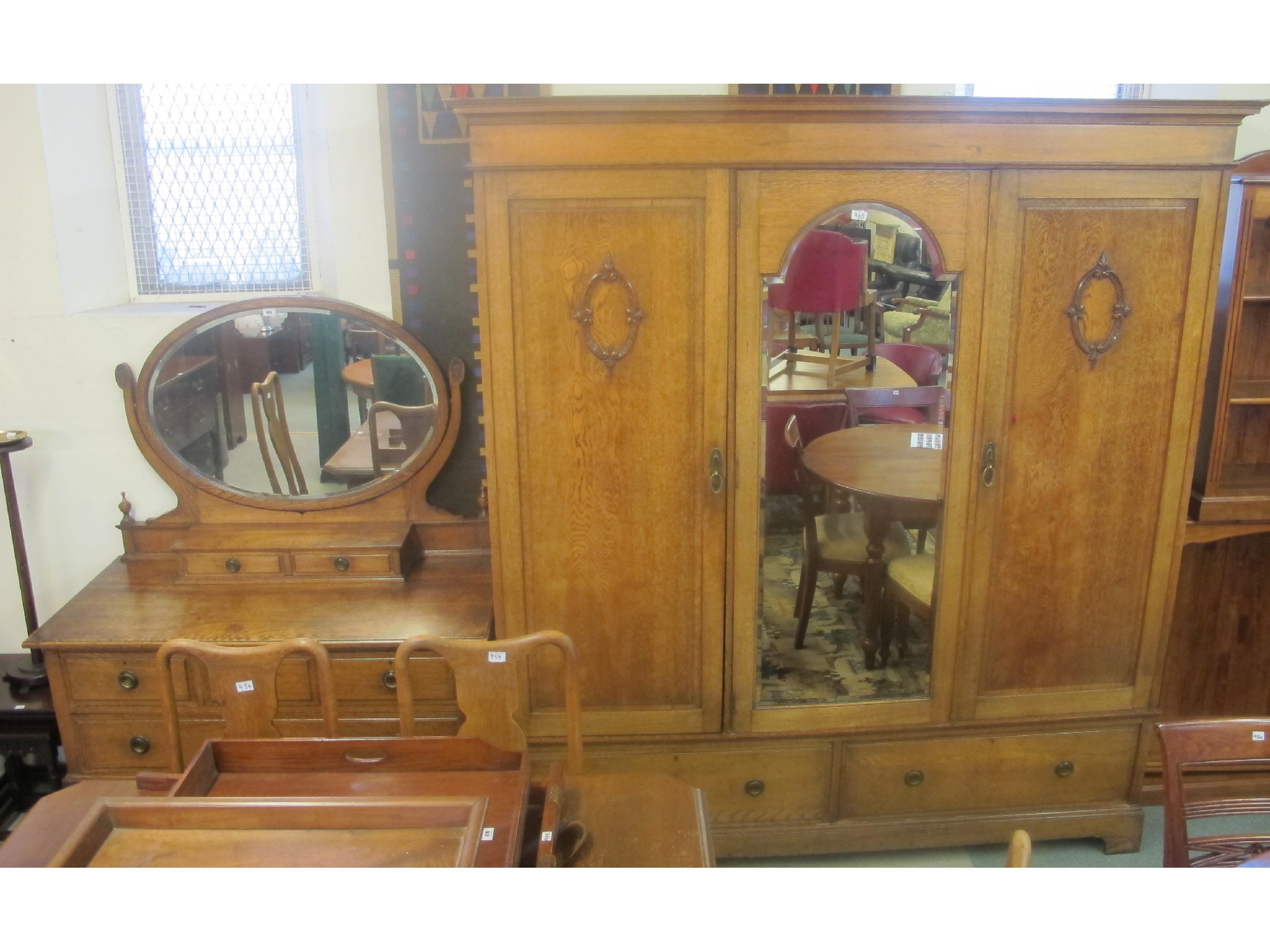 Appraisal: An oak mirrored door wardrobe and dressing table