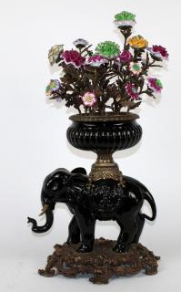 Appraisal: Painted bronze elephant with floral bouquet Painted bronze elephant with