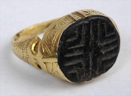 Appraisal: EARLY PERSIAN STONE STAMP SET IN A GOLD RING Size