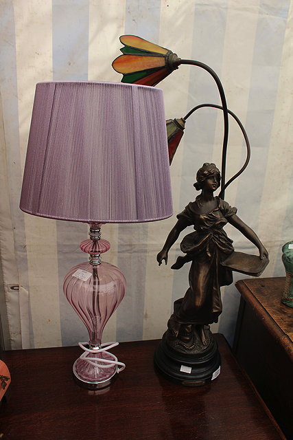 Appraisal: A SPELTER TABLE LAMP with a figure of commerce and