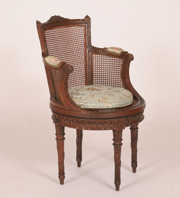 Appraisal: French bergere swivel library chair classical theme carvings on all