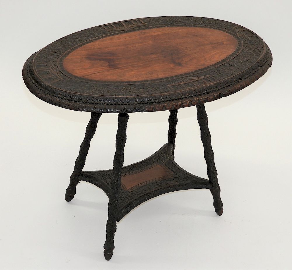 Appraisal: Anglo-Indian Carved Hardwood Side Table India Circa Oval top with