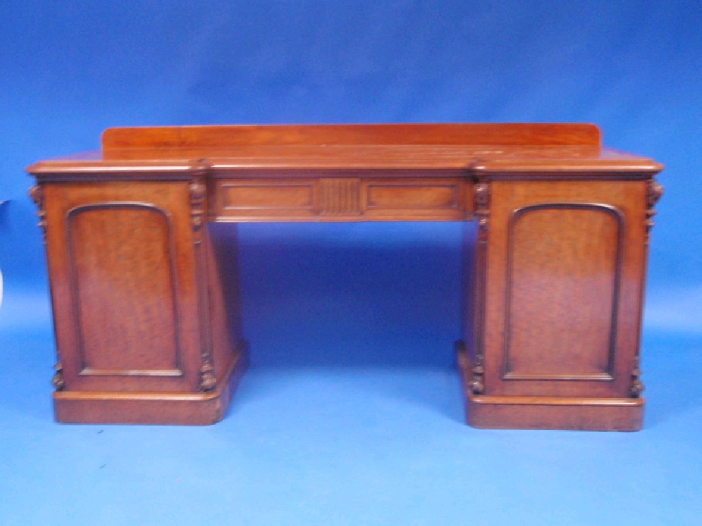 Appraisal: A Victorian mahogany inverted breakfront mahogany sideboard with central drawer