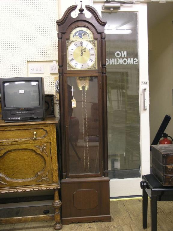 Appraisal: A reproduction mahogany longcase clock arched brass dial with moon