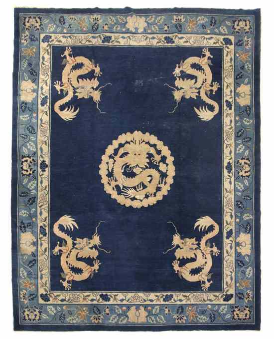 Appraisal: A Chinese Wool Rug decorated with dragons on a blue