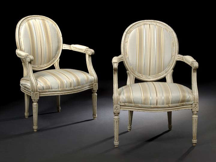 Appraisal: Pair of Louis XVI-Style Cream-Painted Beechwood Fauteuils second quarter th