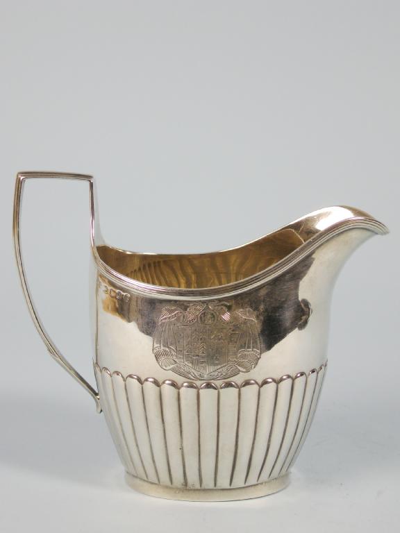 Appraisal: A George III semi-fluted oval Cream Jug engraved with crest