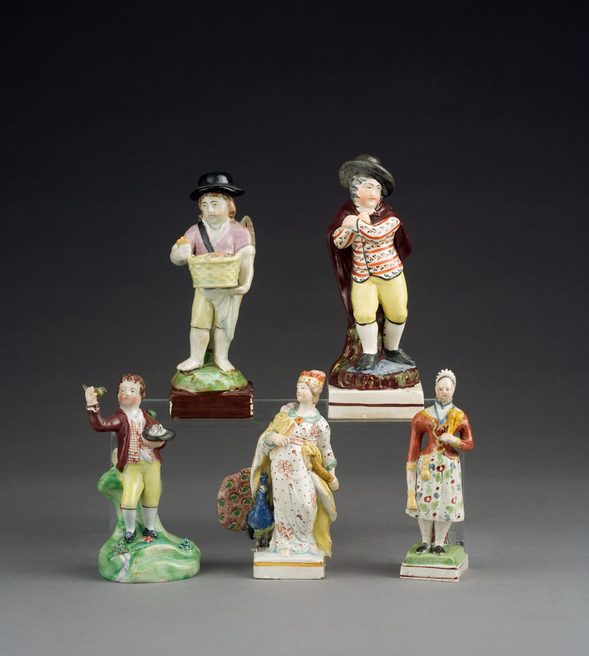 Appraisal: FIVE STAFFORDSHIRE POTTERY FIGURES CIRCA - Comprising a boy birdnesting