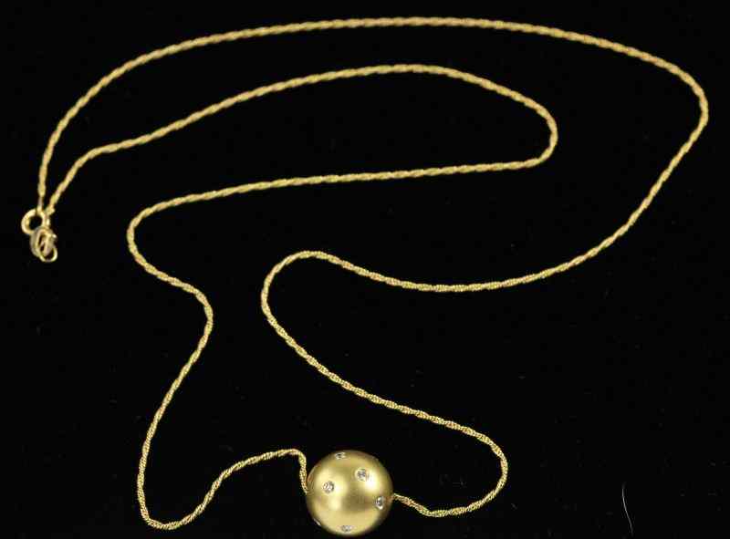 Appraisal: Gold and Diamond Pendant and Chaindesigned as a round ball