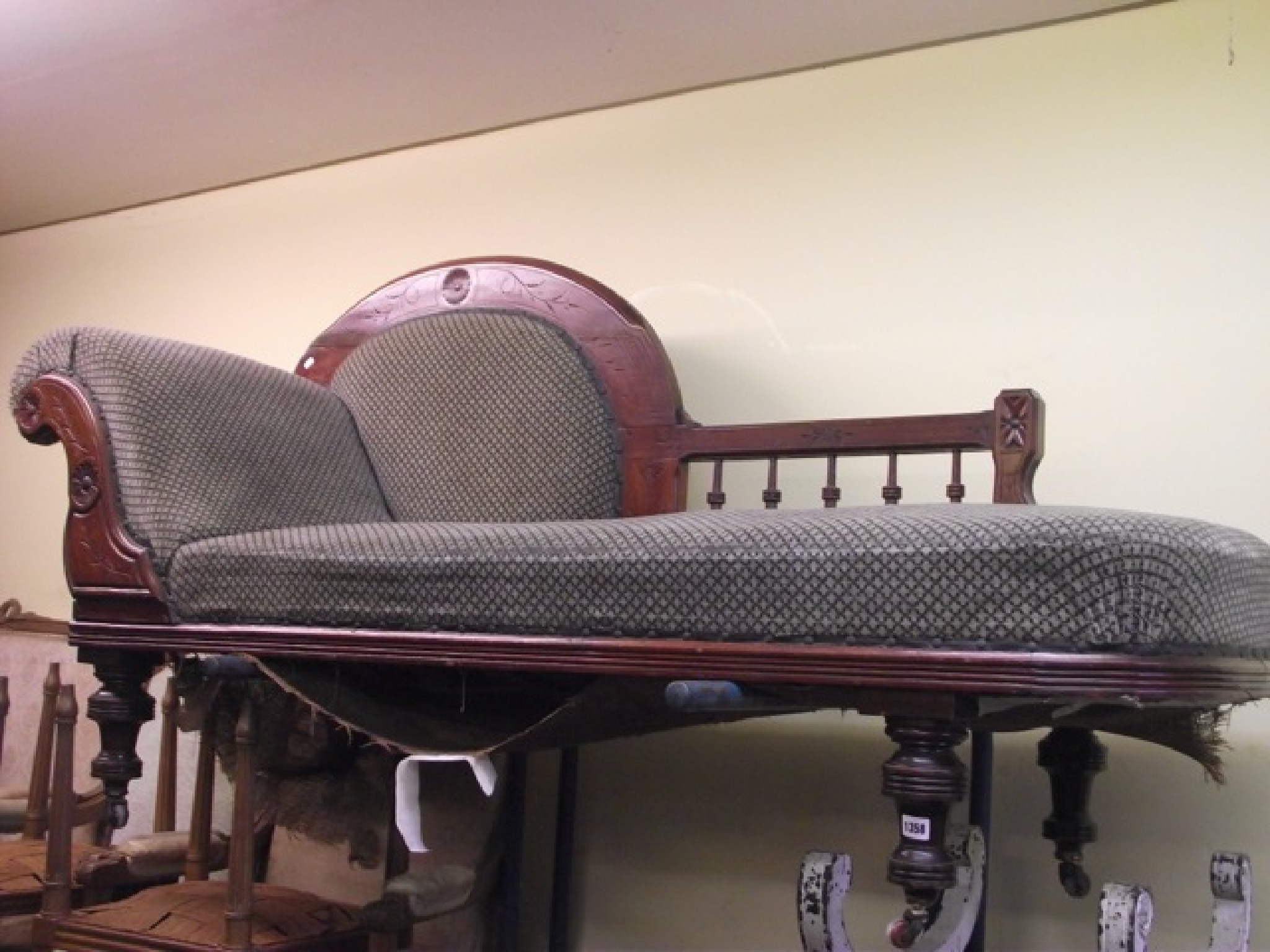 Appraisal: A Victorian mahogany chaise lounge raised on turned supports with