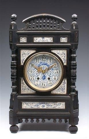 Appraisal: AN ARTS AND CRAFTS EBONISED MANTEL CLOCK with inset blue