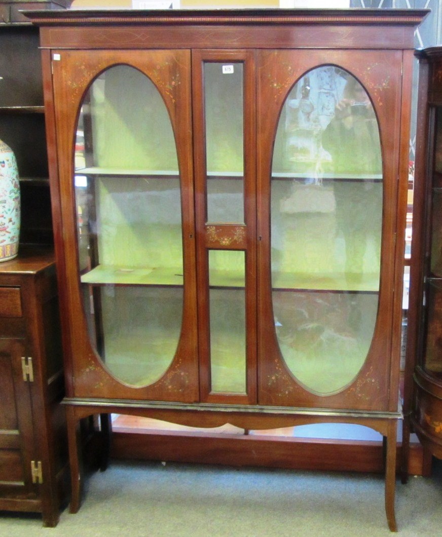 Appraisal: An Edwardian inlaid floral painted mahogany two door dsiplay cabinet