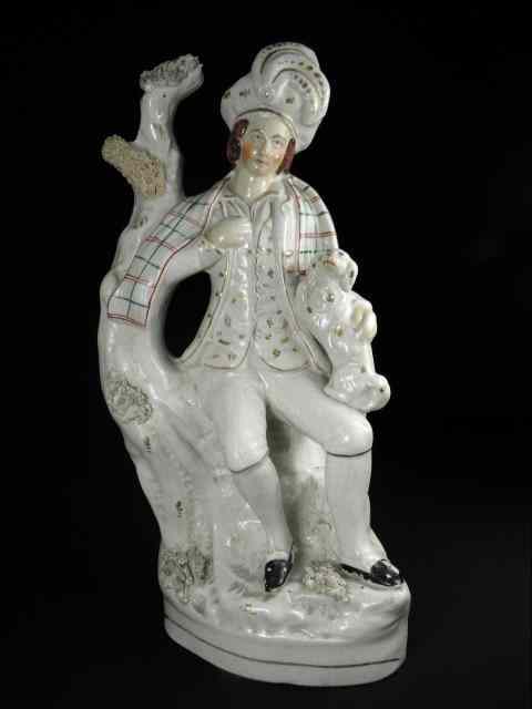 Appraisal: Staffordshire th century figurine depicting a man with dog on