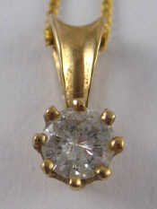 Appraisal: A yellow metal tests carat gold diamond solitaire pendant and