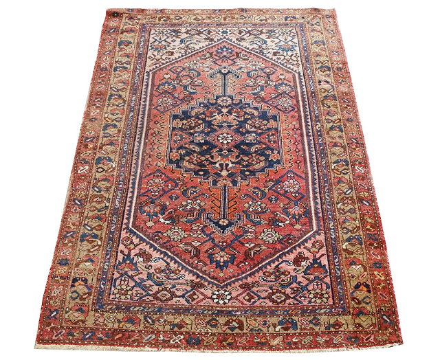 Appraisal: A PERSIAN ROSE GROUND RUG with central blue ground medallion