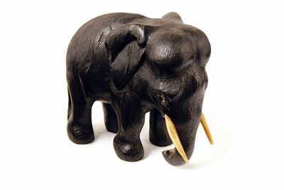 Appraisal: A carved ebony elephant with tusks and inset eyes in