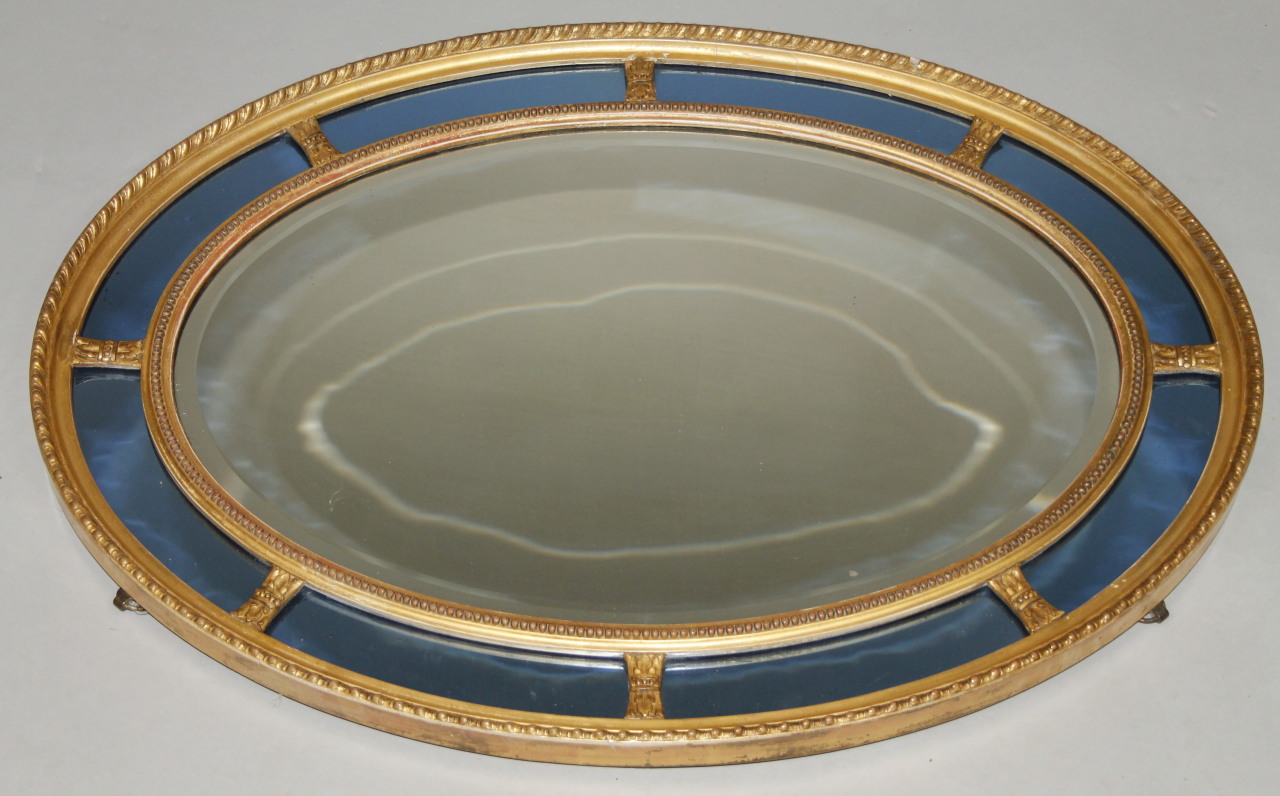 Appraisal: A Regency style Irish oval hanging mirror with sectional glass