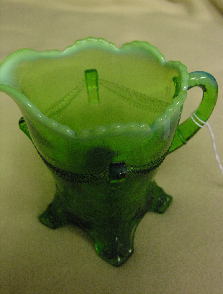 Appraisal: GREEN OPALESCENT FOOTED CREAMER Size by