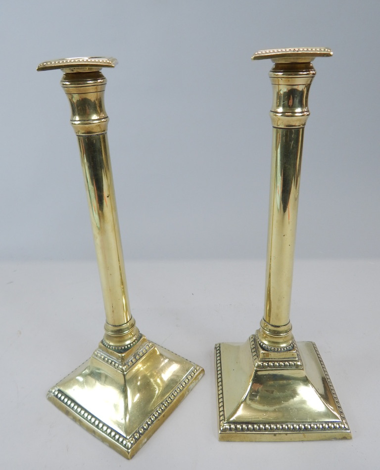 Appraisal: A pair of thC brass column candlesticks with a beaded