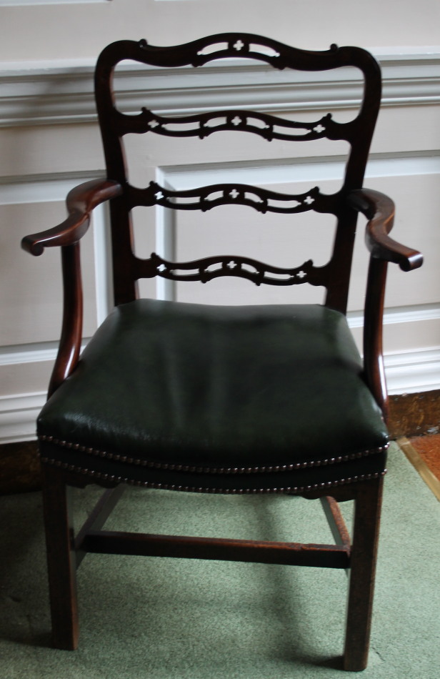 Appraisal: A George III mahogany open arm chair with a pierced