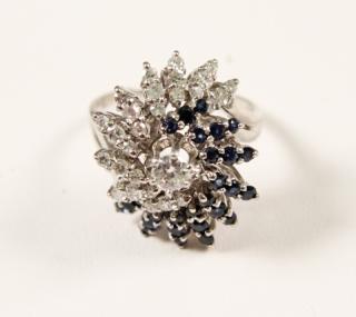 Appraisal: K SWIRL DESIGN DIAMOND AND SAPPHIRE LADY'S RING K WHITE