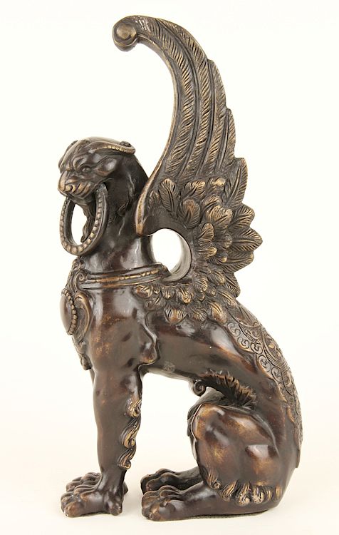 Appraisal: BRONZE SEATED SPHINX FIGURE A bronze seated sphinx figure Wd