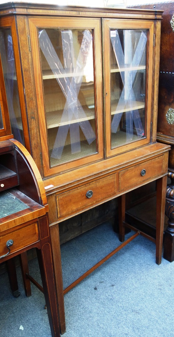 Appraisal: A late th century rosewood banded satinwood two door display