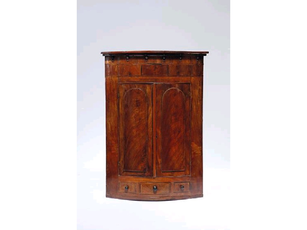 Appraisal: A GEORGE III MAHOGANY HANGING BOWFRONT CORNER CUPBOARD the top