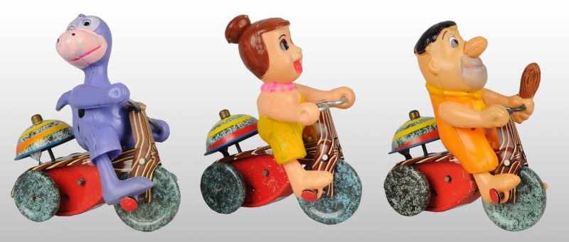 Appraisal: Lot of Celluloid Tin Flintstone Tricycle Toys Description Japanese Circa