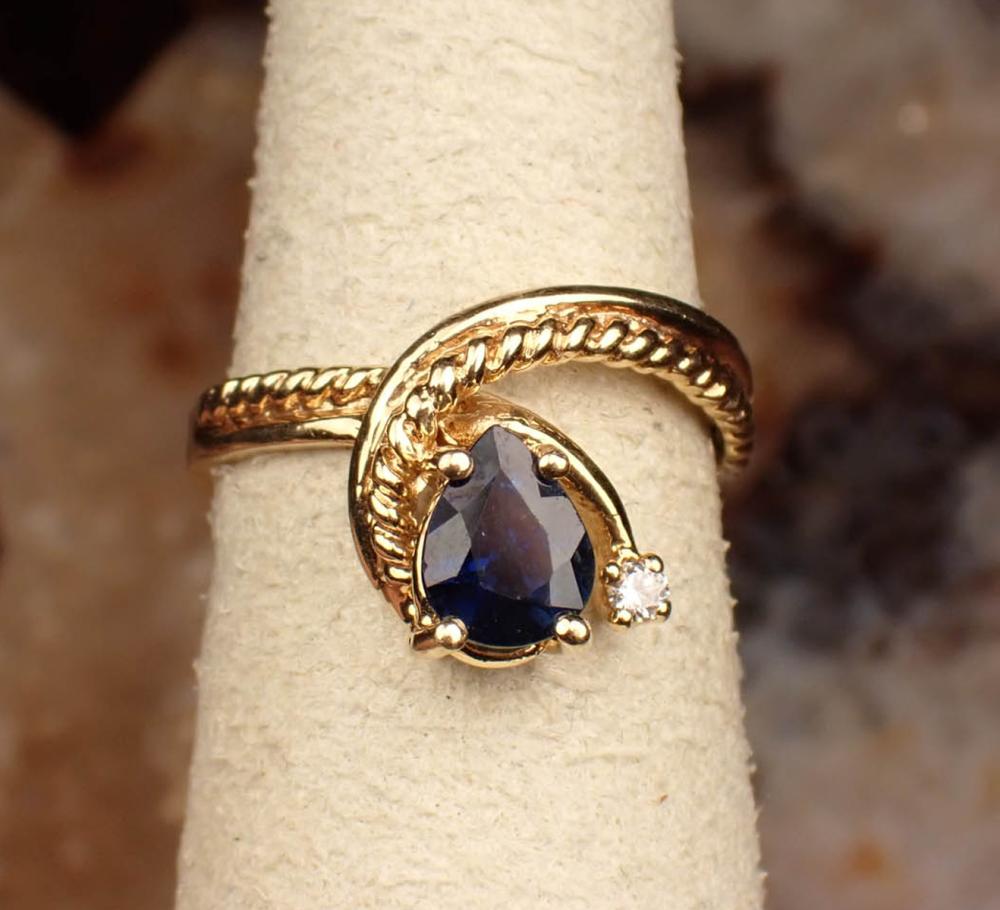 Appraisal: SAPPHIRE DIAMOND AND FOURTEEN KARAT GOLD RING The yellow gold