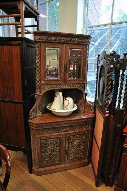 Appraisal: AN OAK CORNER CABINET IN THE TH CENTURY FLEMISH MANNER