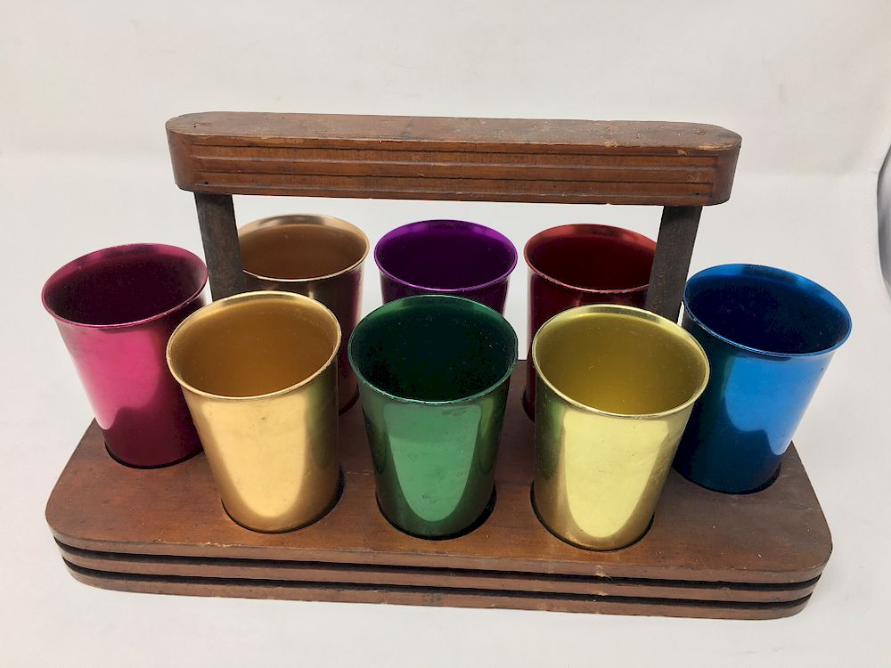 Appraisal: Eight Norben Ware Aluminum Cups Fitted Tray Multi-Color Cups With