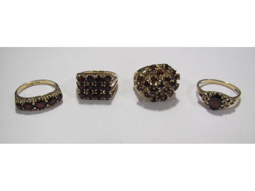 Appraisal: Four ct gold garnet set dress rings