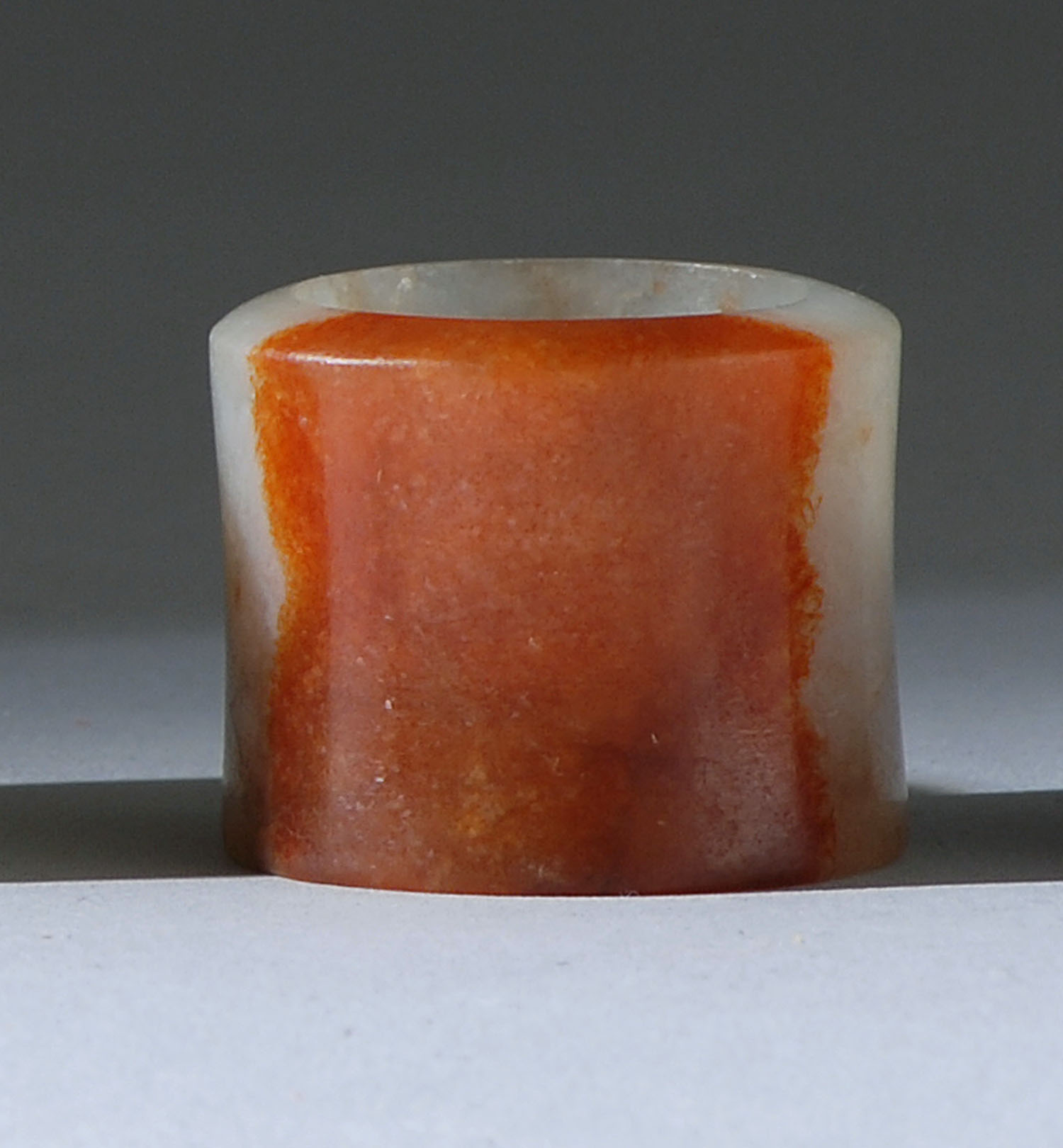 Appraisal: RUSSET AND PALE GREEN JADE SCHOLAR'S RING th CenturyIn simple