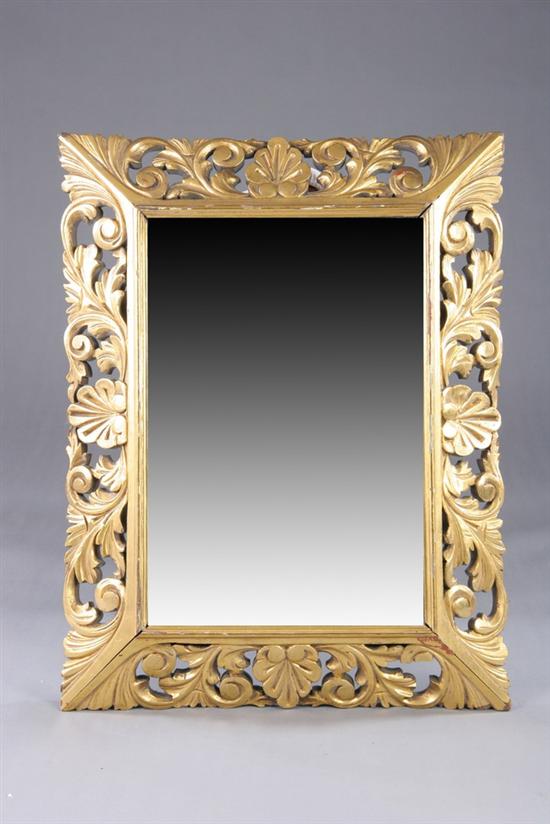 Appraisal: ART DECO INSPIRED WALL MIRROR th century With shell-and-foliate carving