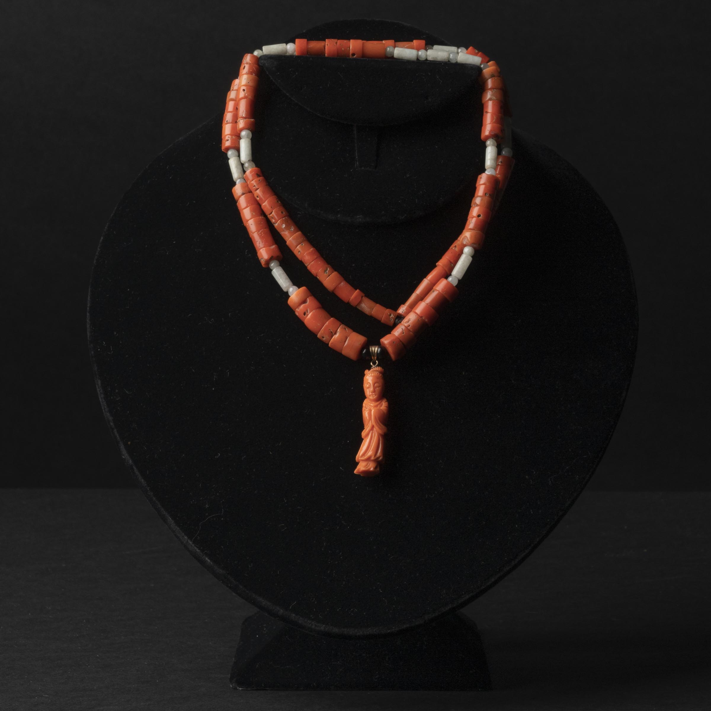 Appraisal: A Carved Coral Necklace With a Carved Coral 'Beauty' Figural